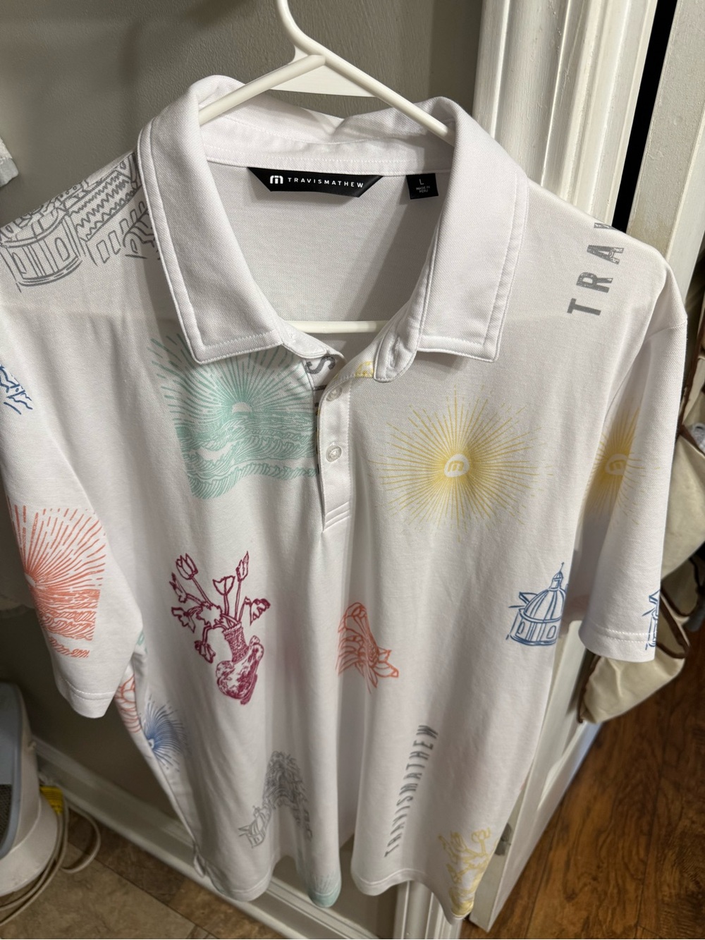 Travis Mathew White Polo with Multi-Color Graphic Accents